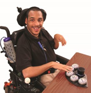 Photo of man working with adaptive technology