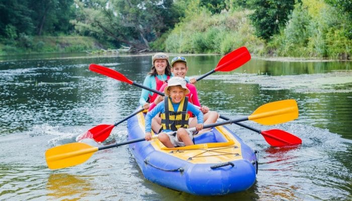 Photo of adult and 2 children in a kayak
