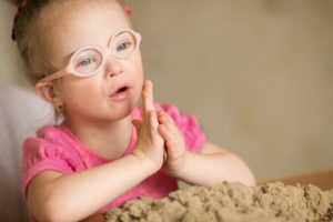 Photo of child playing with sand