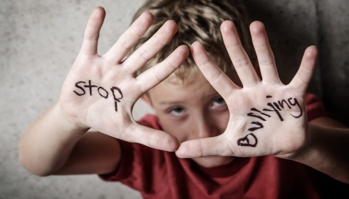 Image of child with "Stop Bullying" written on his palms
