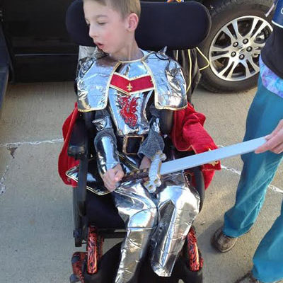 Photo of child in wheelchair dressed as a knight