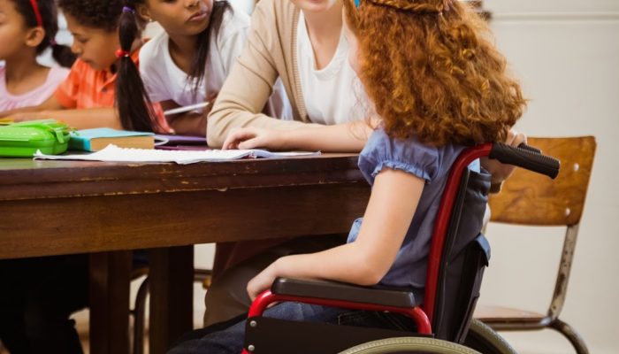 Image of teacher with disabled student