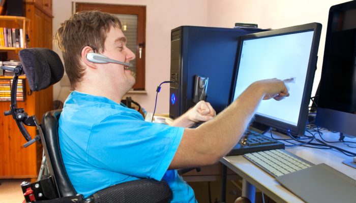 Man In Wheelchair Working on a Computer
