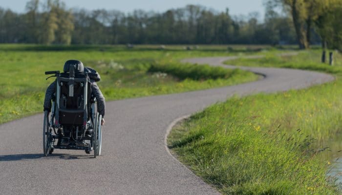 Man in Wheelchair on a Winding Road