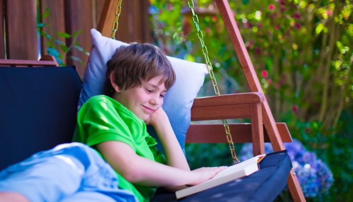Boy on Porch Swing Reading a Book
