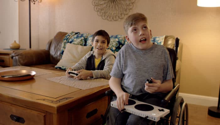 Disabled Boy playing with microsoft adapted controller