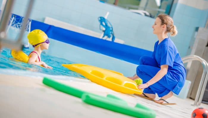 Therapist Working with Girl in a Pool