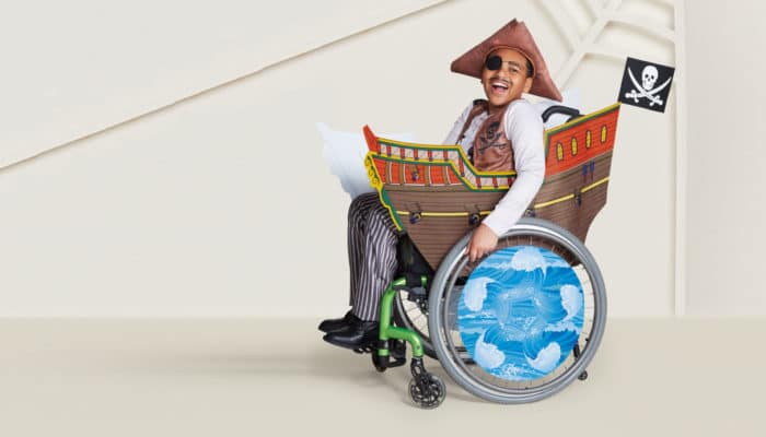 a child in a wheelchair dressed as a pirate