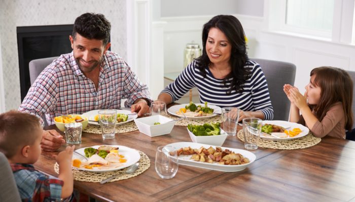 Family of Four Enjoying Dinner Together